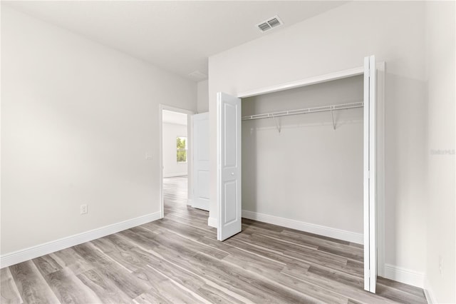 501 Marion Oaks Golf Way, Ocala, FL 34473 - unfurnished bedroom featuring wood finished floors, a closet, and baseboards