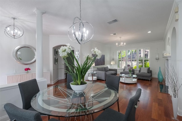 920 Cool Springs Cir, Ocoee, FL 34761 - dining area featuring a chandelier, wood finished floors, ornate columns, crown molding, and baseboards