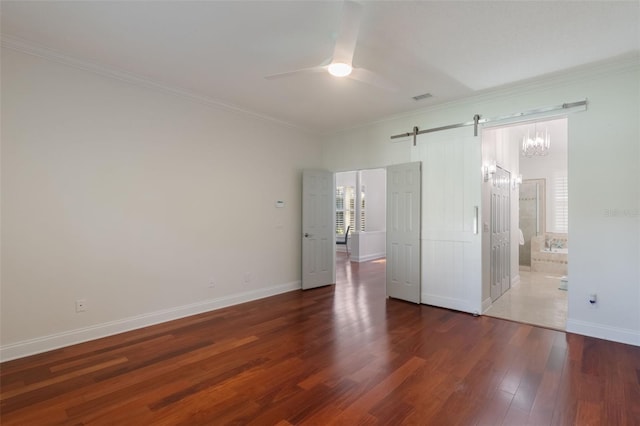 920 Cool Springs Cir, Ocoee, FL 34761 - unfurnished bedroom featuring a barn door, wood finished floors, ornamental molding, baseboards, and ceiling fan