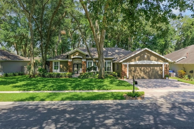 920 Cool Springs Cir, Ocoee, FL 34761 - ranch-style home with a garage, driveway, a front yard, and french doors