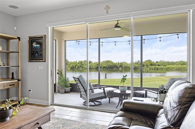 15208 Lake Claire Overlook Dr, Winter Garden, FL 34787 - living area with a water view, baseboards, and a ceiling fan