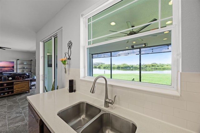 15208 Lake Claire Overlook Dr, Winter Garden, FL 34787 - kitchen with a sink, a water view, dishwasher, ceiling fan, and backsplash