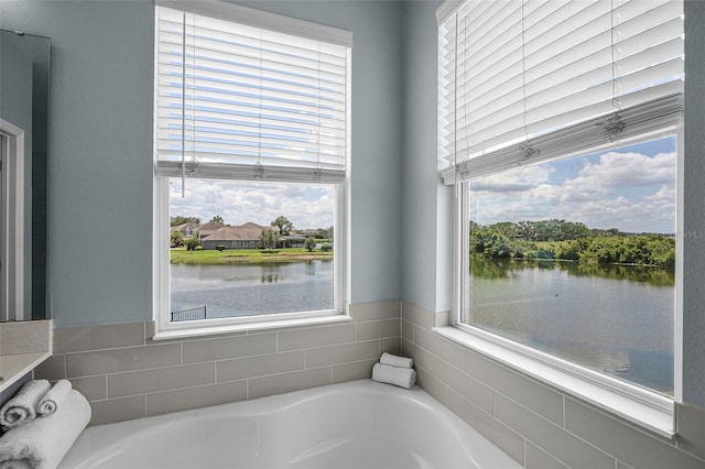 15208 Lake Claire Overlook Dr, Winter Garden, FL 34787 - bathroom featuring a garden tub, plenty of natural light, and a water view
