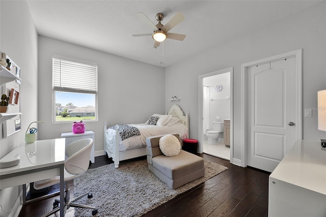 15208 Lake Claire Overlook Dr, Winter Garden, FL 34787 - bedroom with dark wood-type flooring, ensuite bath, ceiling fan, and baseboards