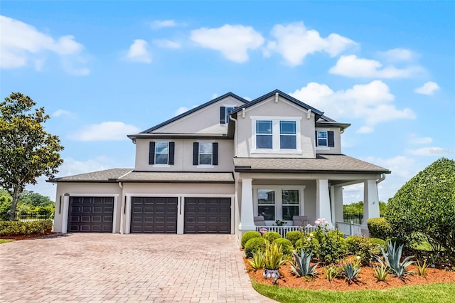 15208 Lake Claire Overlook Dr, Winter Garden, FL 34787 - view of front of property featuring a porch, stucco siding, decorative driveway, and a garage
