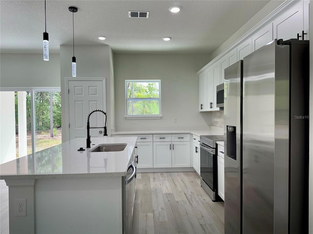 152 W Diego Pl, Citrus Springs, FL 34434 - kitchen featuring appliances with stainless steel finishes, a sink, light wood-style flooring, white cabinets, and recessed lighting
