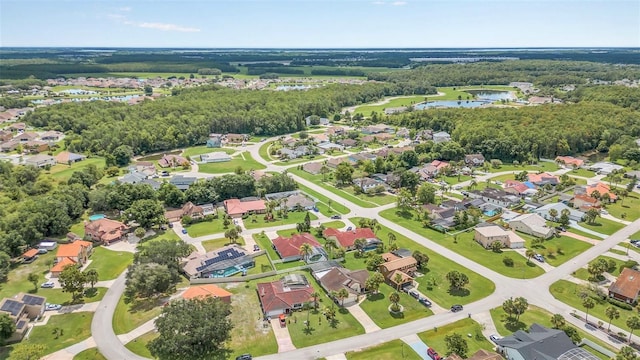 aerial overview of property's location with a nearby body of water and nearby suburban area