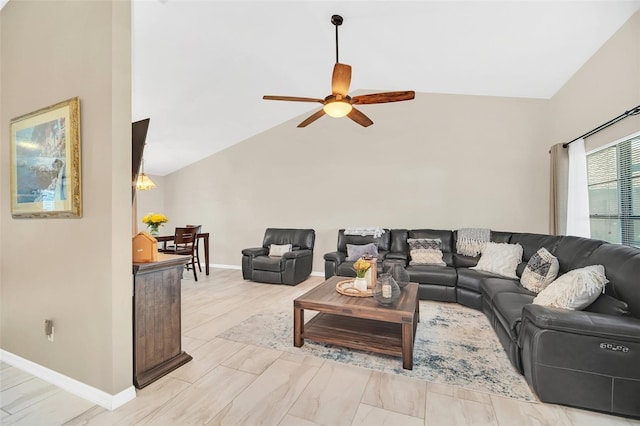 living area with ceiling fan, lofted ceiling, and baseboards