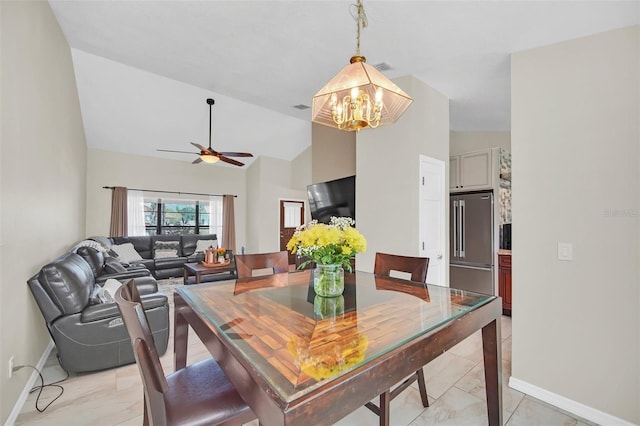 dining area featuring a chandelier, a ceiling fan, baseboards, and high vaulted ceiling