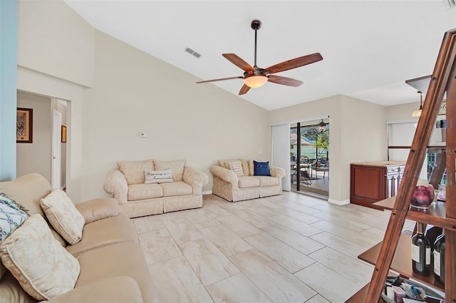 living area with ceiling fan and high vaulted ceiling