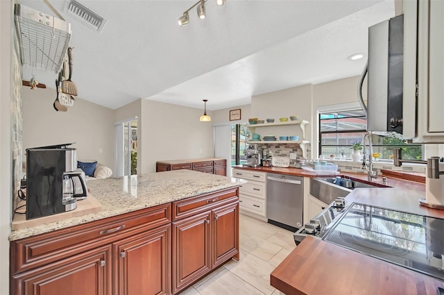kitchen with dishwasher, a sink, open shelves, and plenty of natural light