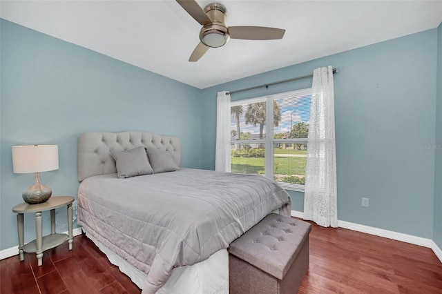 bedroom with wood finished floors, baseboards, and a ceiling fan