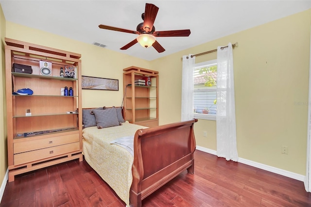 bedroom featuring wood finished floors, baseboards, and ceiling fan