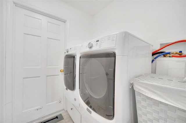 washroom with independent washer and dryer