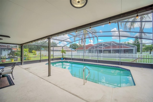 view of pool with a fenced backyard, a patio area, and a lanai