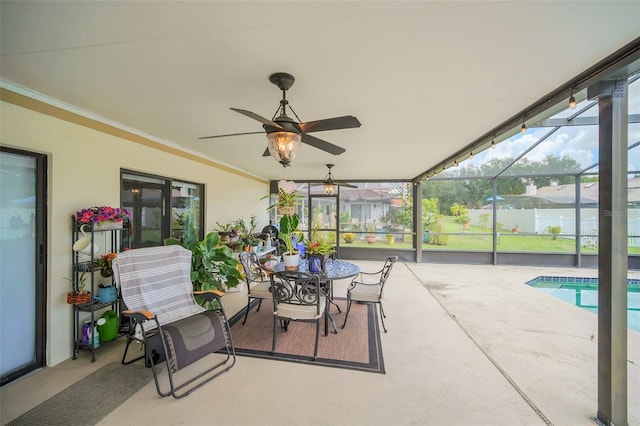 sunroom with ceiling fan and outdoor dining space