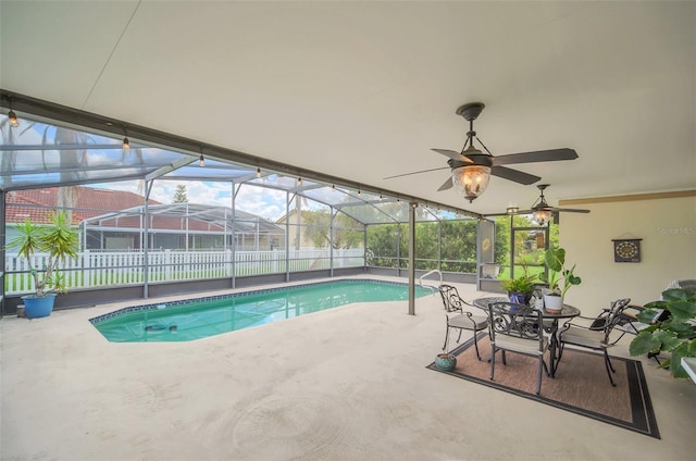 view of swimming pool with a patio, a lanai, and ceiling fan