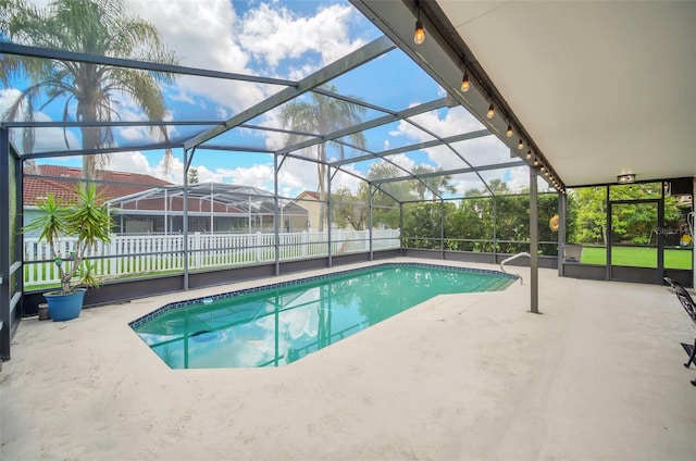 outdoor pool with a patio area and a lanai