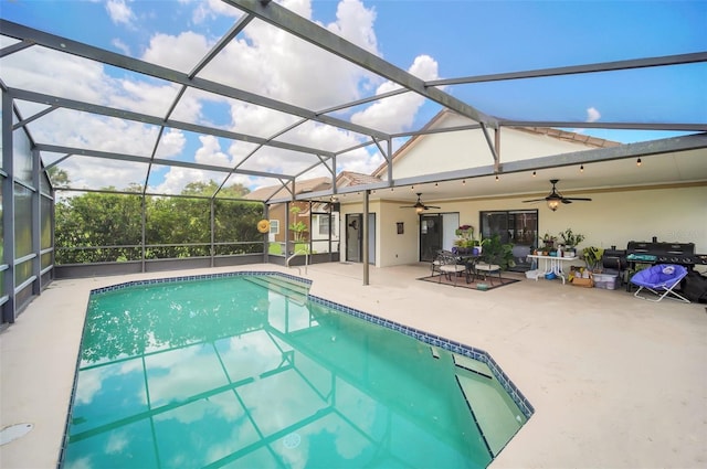 outdoor pool with ceiling fan, a patio area, and a lanai