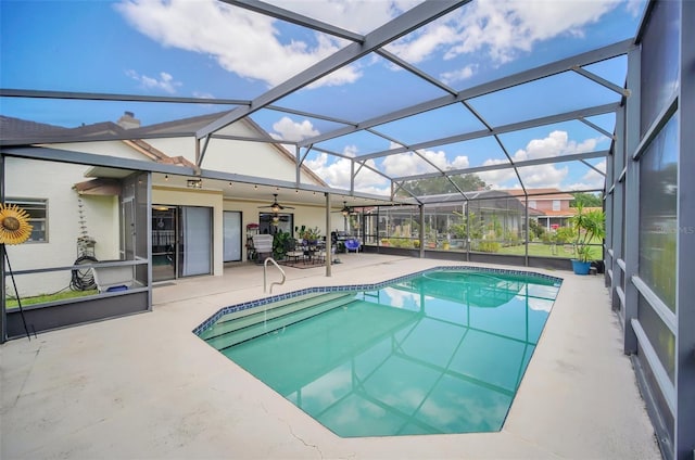 swimming pool featuring a patio area, ceiling fan, and glass enclosure