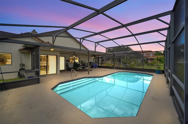 swimming pool featuring a patio, ceiling fan, and glass enclosure