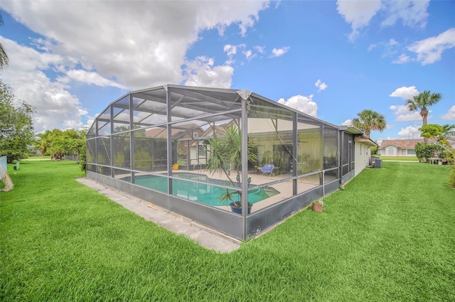 outdoor pool featuring a lawn