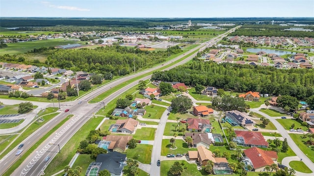 aerial overview of property's location with nearby suburban area, a highway, and a large body of water