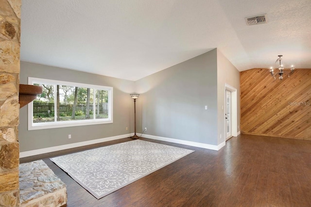 2320 Wekiva Ridge Rd, Apopka, FL 32712 - unfurnished living room with a chandelier, dark wood-style flooring, baseboards, wooden walls, and lofted ceiling
