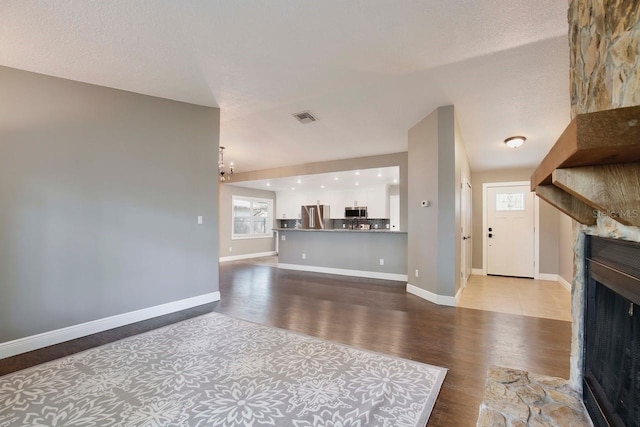 2320 Wekiva Ridge Rd, Apopka, FL 32712 - unfurnished living room featuring a fireplace, wood finished floors, and baseboards