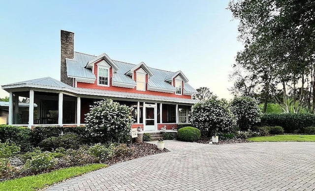 11317 NW 199th Ave, Alachua, FL 32615 - new england style home with a porch, a chimney, a standing seam roof, and metal roof