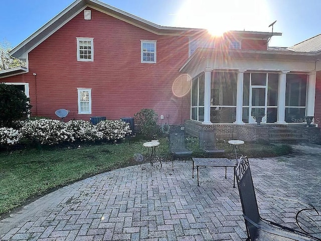 11317 NW 199th Ave, Alachua, FL 32615 - view of side of property with a patio and a sunroom