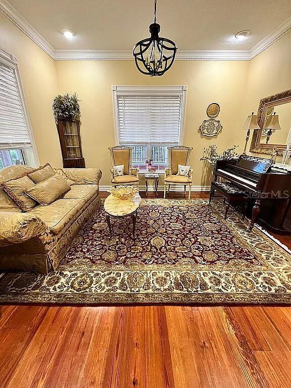 11317 NW 199th Ave, Alachua, FL 32615 - sitting room featuring a chandelier, crown molding, wood finished floors, and baseboards