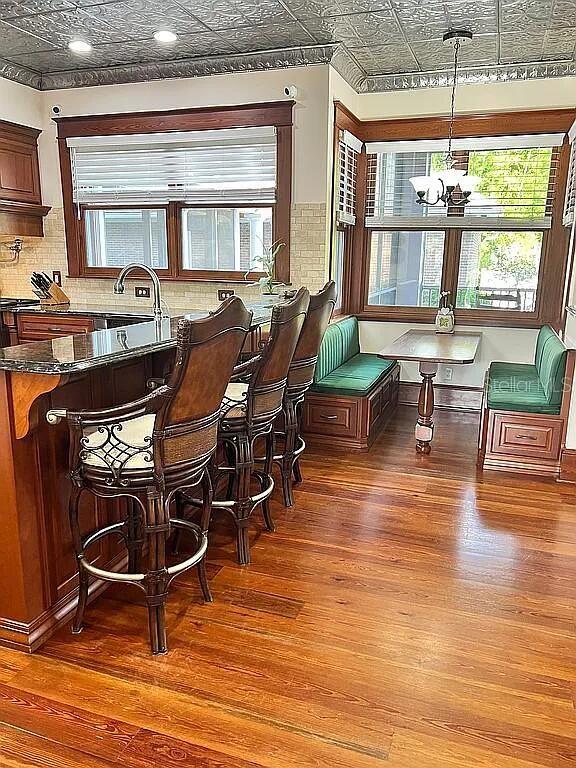 11317 NW 199th Ave, Alachua, FL 32615 - dining room featuring an ornate ceiling, breakfast area, plenty of natural light, wood finished floors, and a chandelier