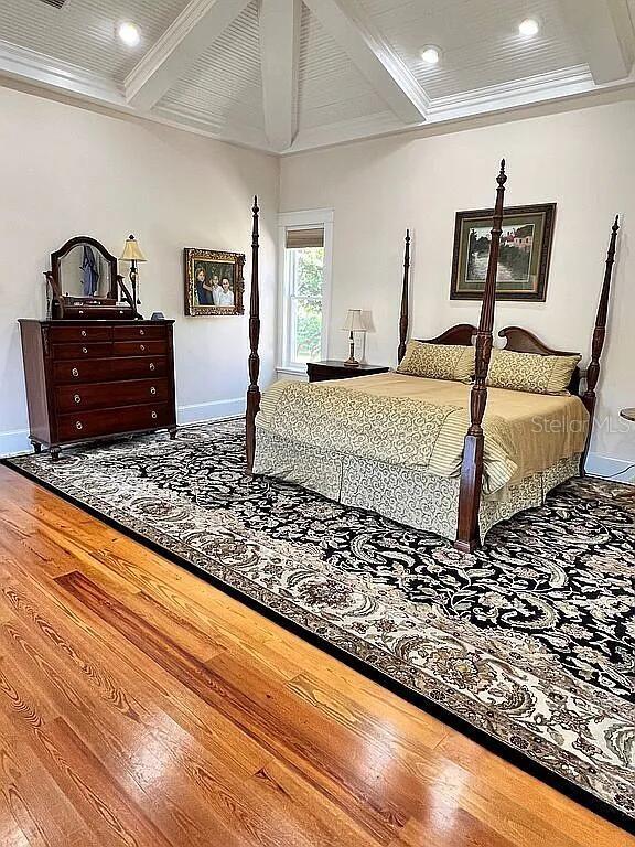 11317 NW 199th Ave, Alachua, FL 32615 - bedroom with wood finished floors, baseboards, beamed ceiling, recessed lighting, and ornamental molding