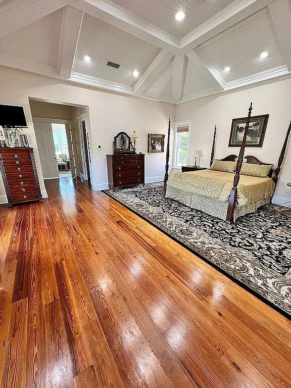 11317 NW 199th Ave, Alachua, FL 32615 - bedroom featuring coffered ceiling, wood finished floors, baseboards, beam ceiling, and recessed lighting