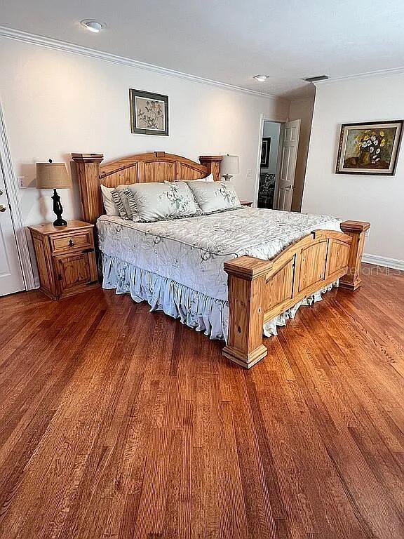 11317 NW 199th Ave, Alachua, FL 32615 - bedroom featuring crown molding and wood finished floors
