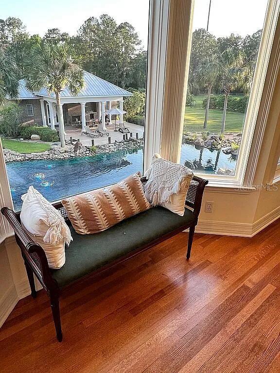 11317 NW 199th Ave, Alachua, FL 32615 - living area with wood finished floors, baseboards, and healthy amount of natural light