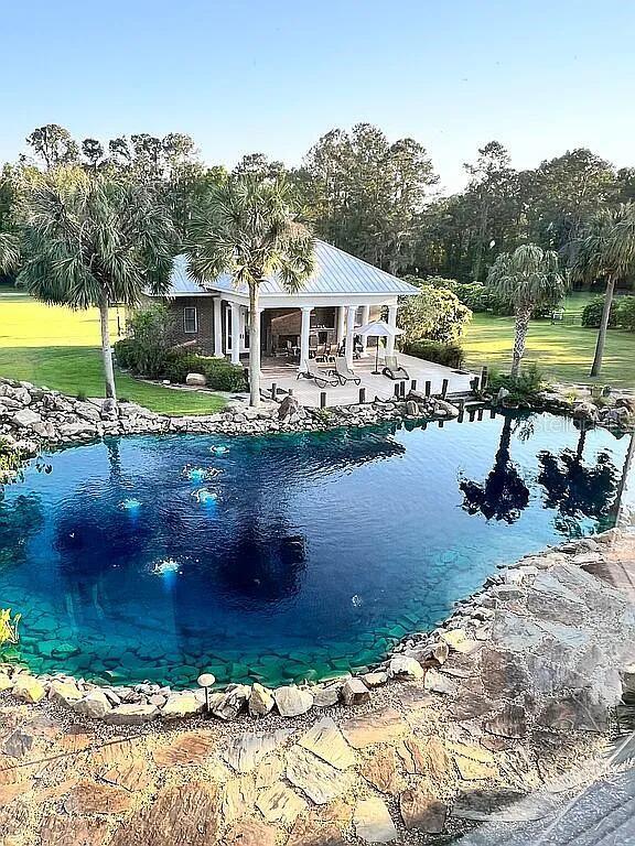 11317 NW 199th Ave, Alachua, FL 32615 - view of pool with a patio, a pool, and a lawn