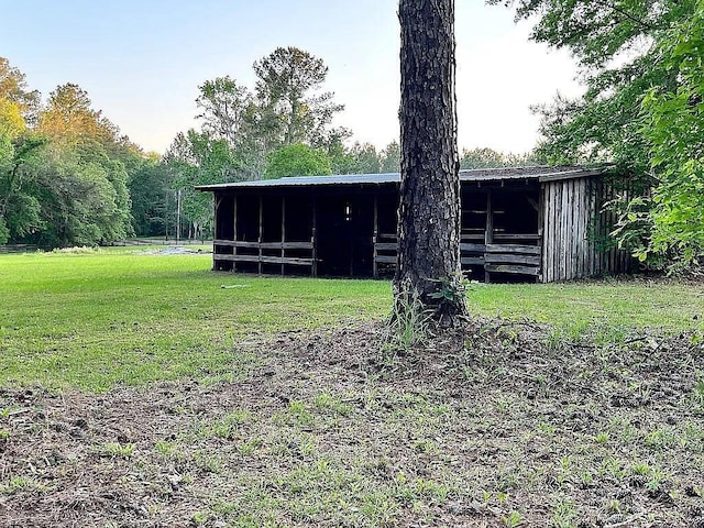 11317 NW 199th Ave, Alachua, FL 32615 - rear view of house featuring a pole building, a yard, and an outbuilding