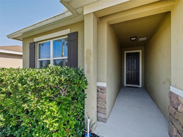 4553 Baler Trails Dr, Saint Cloud, FL 34772 - doorway to property with stucco siding and stone siding