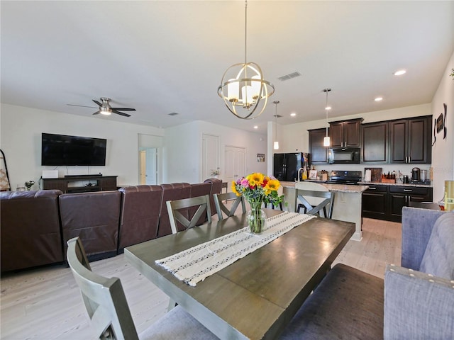 4553 Baler Trails Dr, Saint Cloud, FL 34772 - dining area with a chandelier, light wood-style floors, a ceiling fan, and recessed lighting