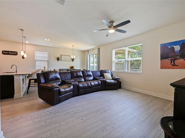 4553 Baler Trails Dr, Saint Cloud, FL 34772 - living area featuring ceiling fan, light wood-type flooring, a chandelier, and baseboards