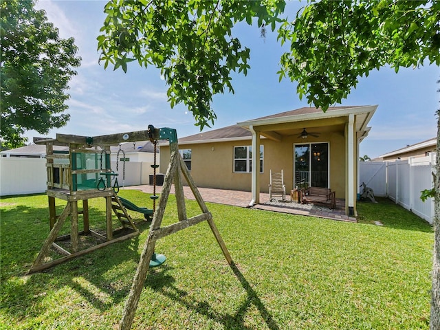 4553 Baler Trails Dr, Saint Cloud, FL 34772 - rear view of house featuring a playground, ceiling fan, stucco siding, and a patio