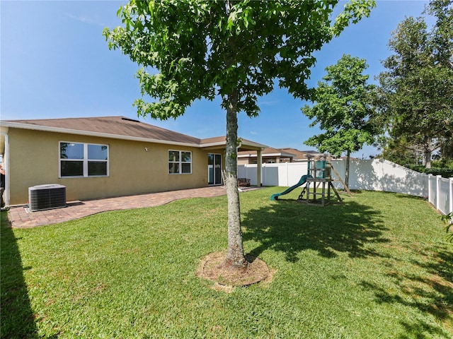 4553 Baler Trails Dr, Saint Cloud, FL 34772 - back of property with stucco siding, a playground, and a patio