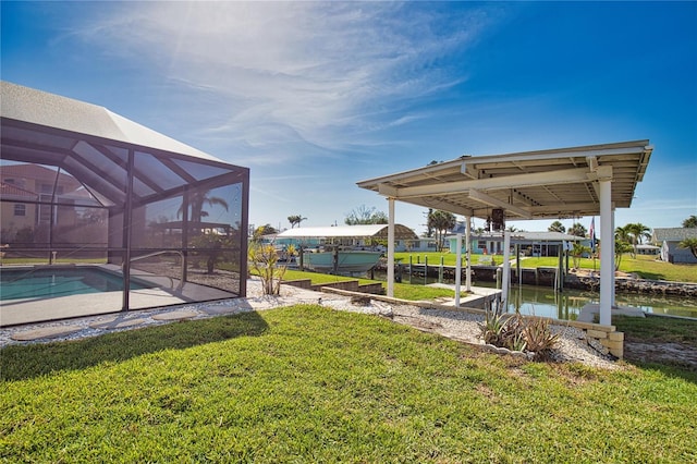 1933 Oregon Trl, Englewood, FL 34224 - view of green lawn with an outdoor pool, a water view, glass enclosure, and a patio area