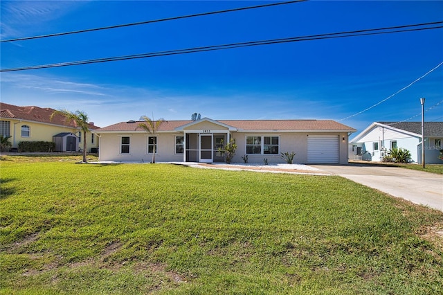 1933 Oregon Trl, Englewood, FL 34224 - ranch-style home with concrete driveway, a garage, stucco siding, a front lawn, and a sunroom