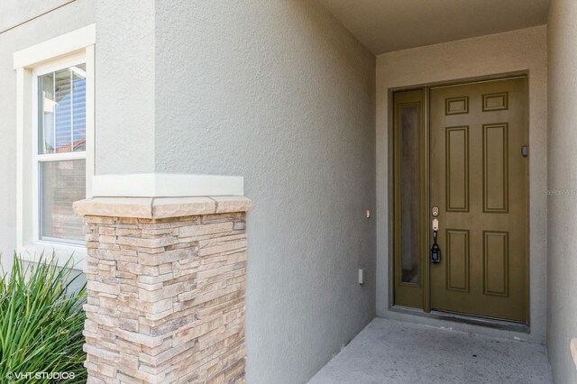 7017 Oakwood St, Davenport, FL 33837 - doorway to property with stucco siding