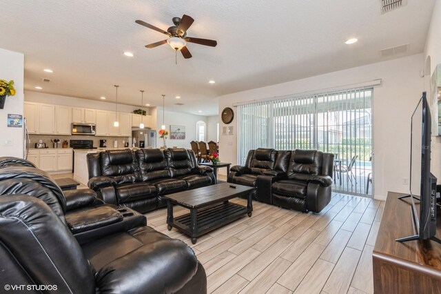 7017 Oakwood St, Davenport, FL 33837 - living area featuring a ceiling fan, light wood-style floors, and recessed lighting
