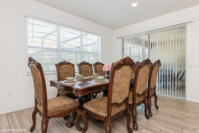 7017 Oakwood St, Davenport, FL 33837 - dining room featuring light wood-style flooring, baseboards, and recessed lighting