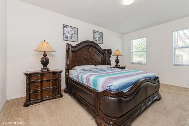 7017 Oakwood St, Davenport, FL 33837 - bedroom with light carpet and baseboards